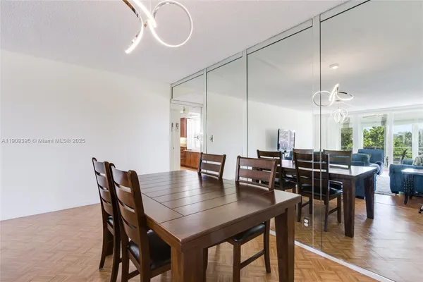 a living room with furniture and a dining table