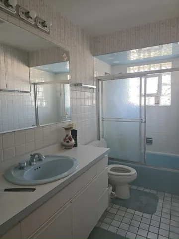 a bathroom with a sink toilet a mirror and shower