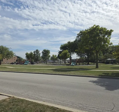 a big yard with lots of green space and trees
