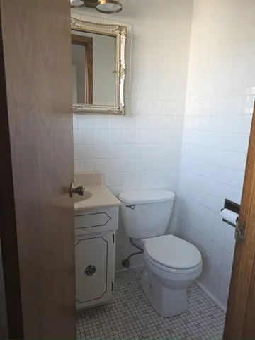 a white toilet sitting next to a white sink