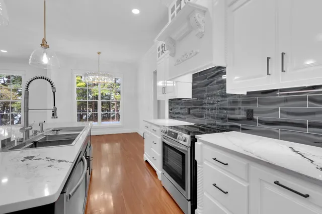 a kitchen with wooden floors and center island