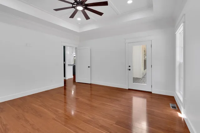 wooden floor in an empty room with a window
