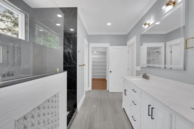 an empty room with window and ceiling fan