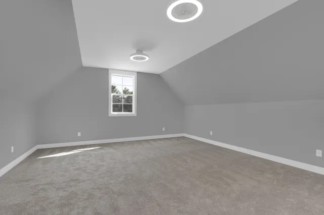 a view of house with yard and large tree in front of it