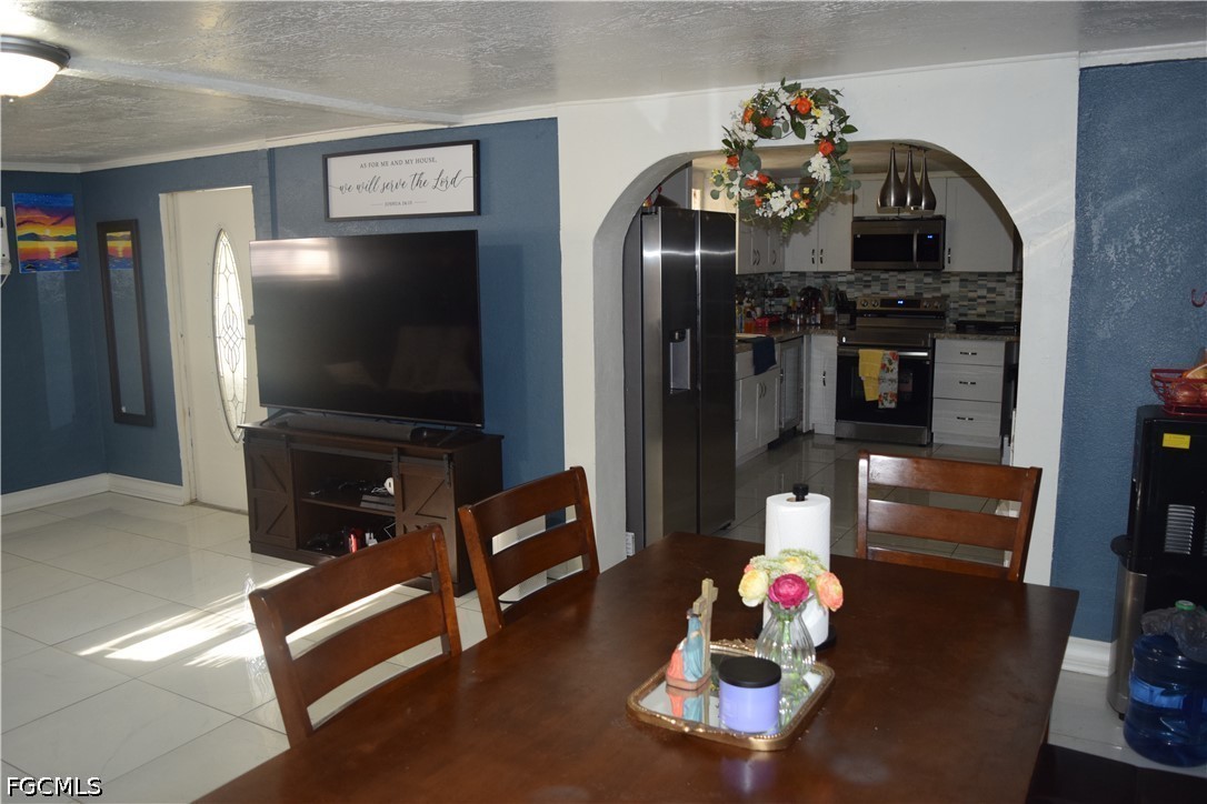 17 Colorado Road Lehigh Acres, FL 33936 - Photo 10 of 17 a living room with furniture and a flat screen tv