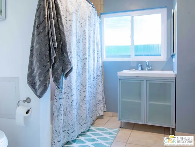 a bathroom with a sink toilet and window