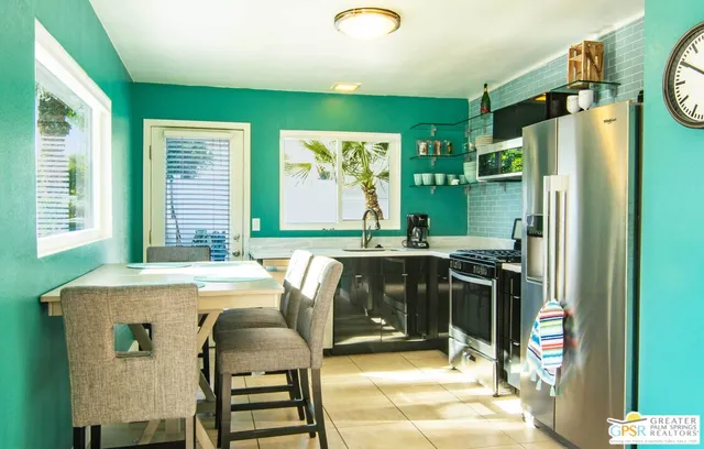 a kitchen with stainless steel appliances granite countertop a refrigerator and a stove