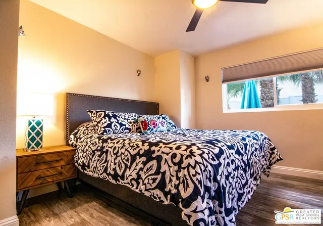 a bed sitting in a bedroom next to a window