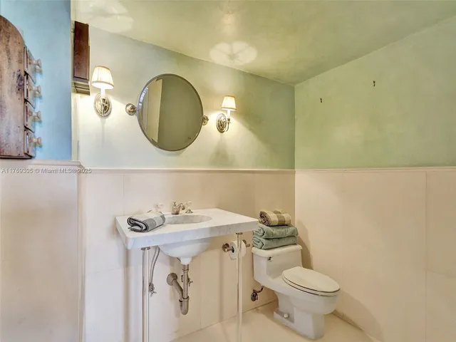 a bathroom with a sink mirror vanity and toilet