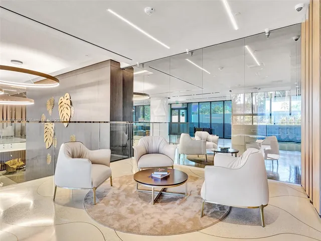 a living room with furniture and a glass door