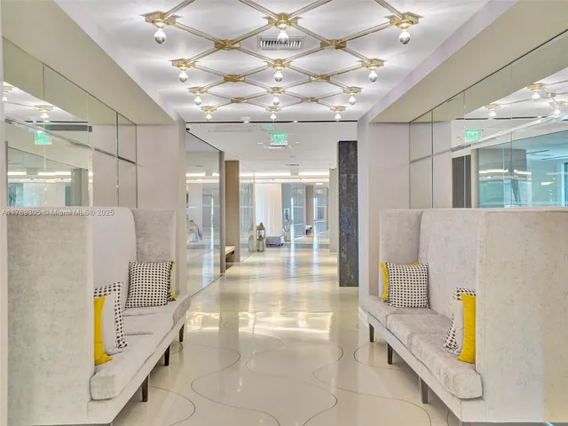 a lobby with furniture and a chandelier