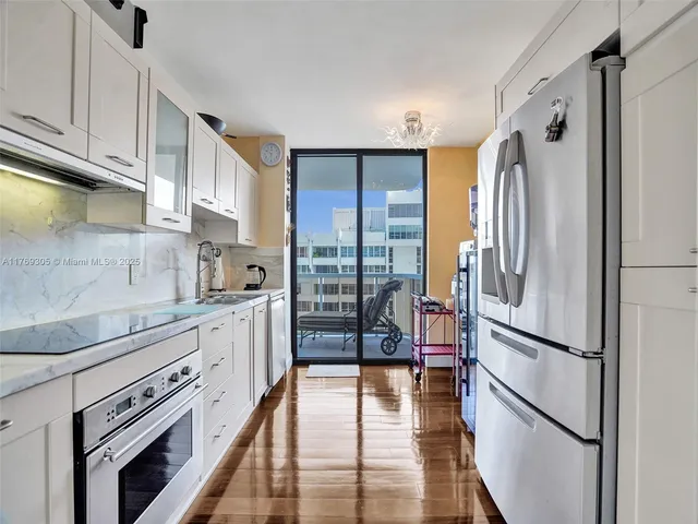 a kitchen with stainless steel appliances a refrigerator sink and cabinets