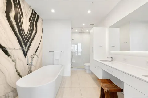 a bathroom with a sink a toilet a tub and a shower