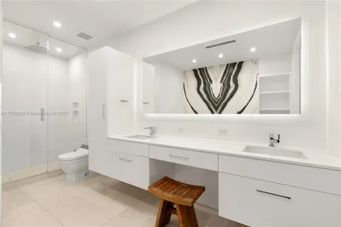 a bathroom with a toilet a sink a mirror and a bathtub