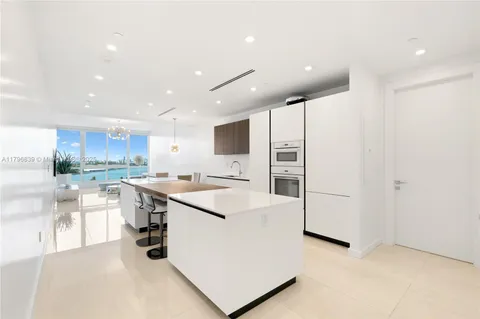 a kitchen with a sink a stove and cabinets