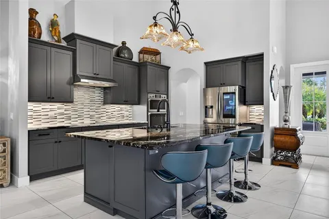 a kitchen with a sink a counter space appliances and cabinets