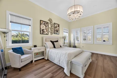 a spacious bedroom with a bed and a chandelier