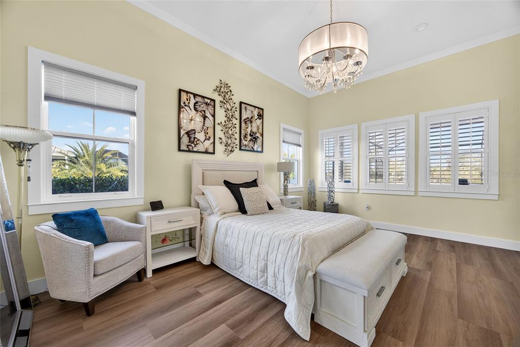 28991 Smugglers Lane Punta Gorda, FL 33982 - Photo 22 of 67 a bedroom with a bed and a chandelier