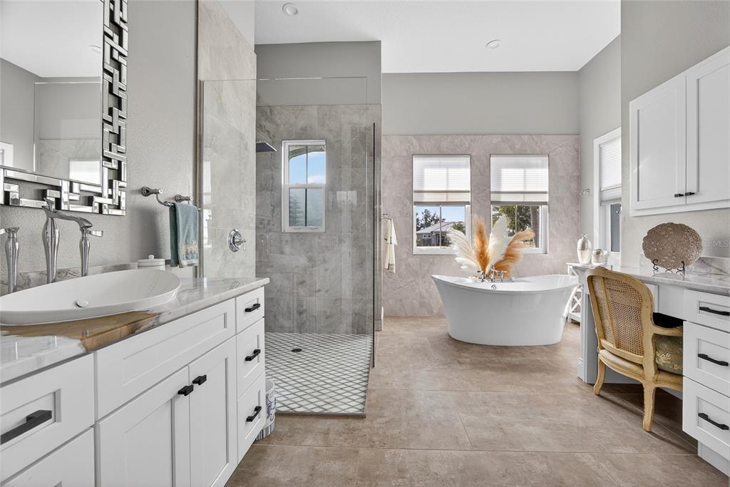 28991 Smugglers Lane Punta Gorda, FL 33982 - Photo 25 of 67 a spacious bathroom with a granite countertop tub sink and mirror