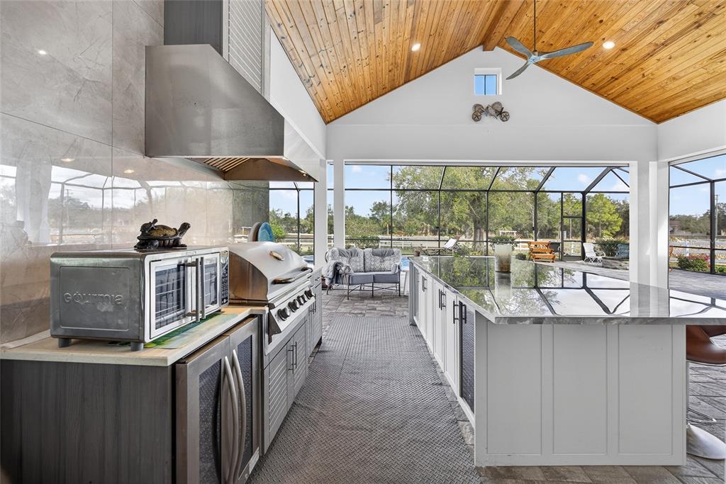 28991 Smugglers Lane Punta Gorda, FL 33982 - Photo 39 of 67 a kitchen with stainless steel appliances granite countertop a stove a sink and a refrigerator