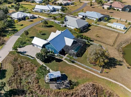 a view of a house with a big yard and large trees