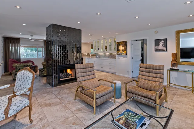 a living room with furniture and kitchen view
