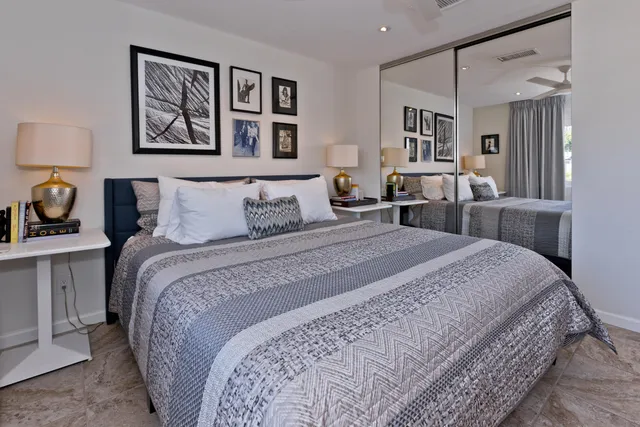 a bathroom with a sink a toilet a mirror and shower