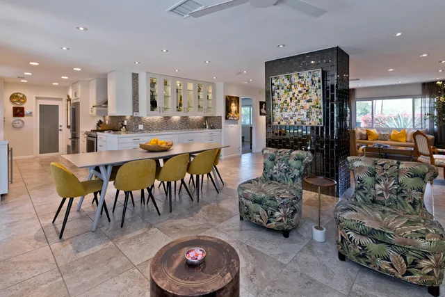 a room with pool table and chairs