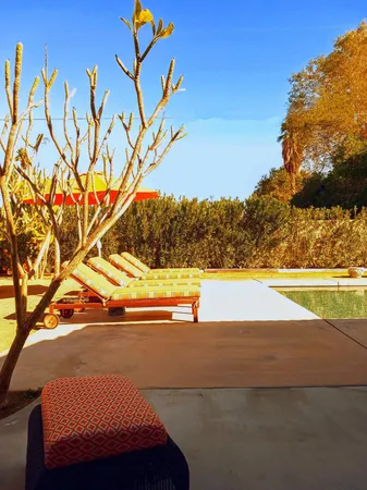 a view of swimming pool with seating area and barbeque oven