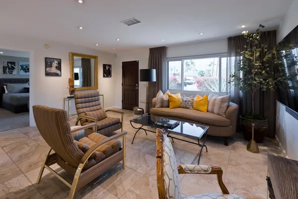 a bedroom with bed and glass walk in closet