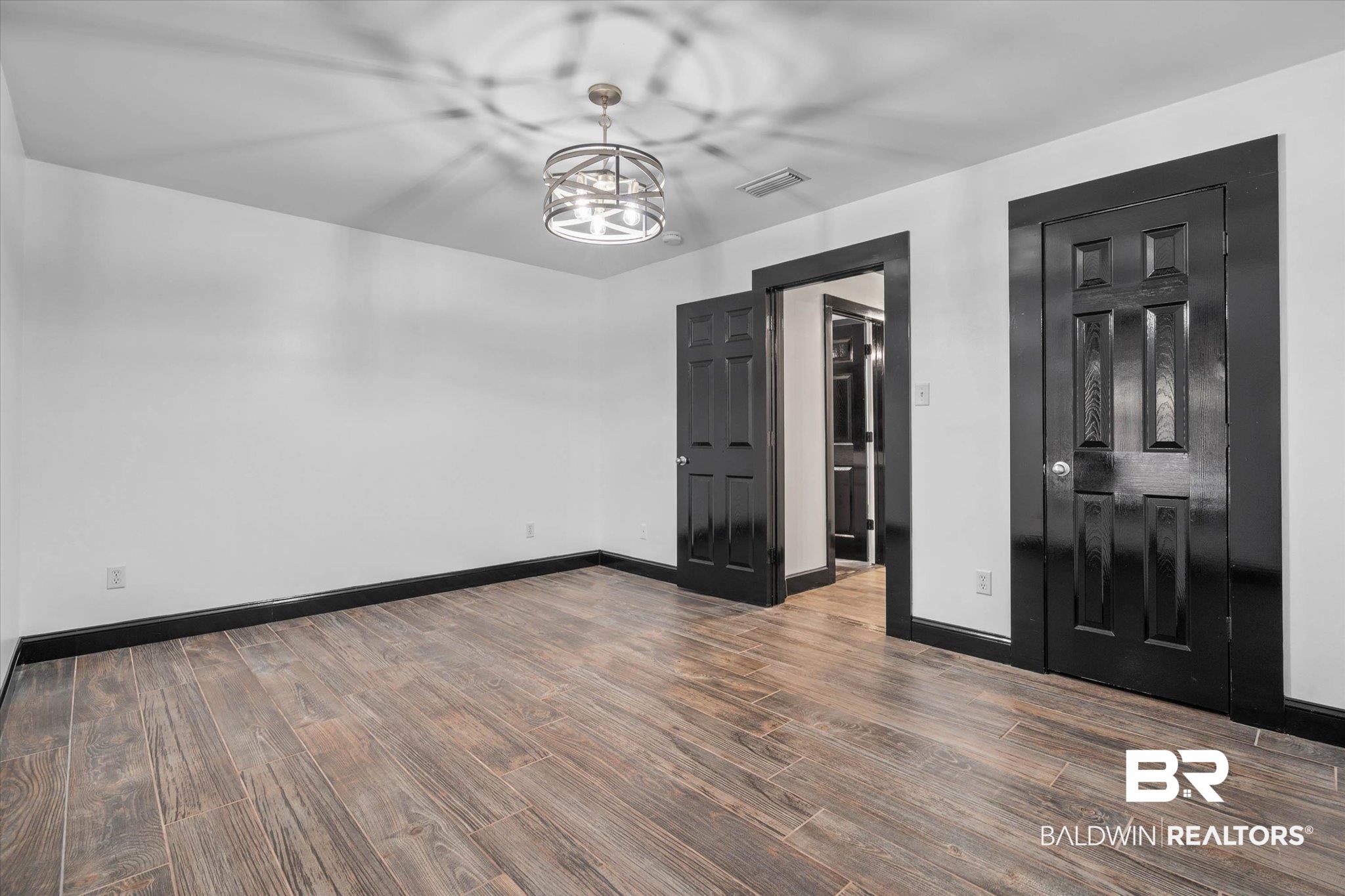 3216 Bay Booster Club Road Theodore, AL 36582 - Photo 17 of 46 Unfurnished dining area featuring dark wood-style floors and hanging lights