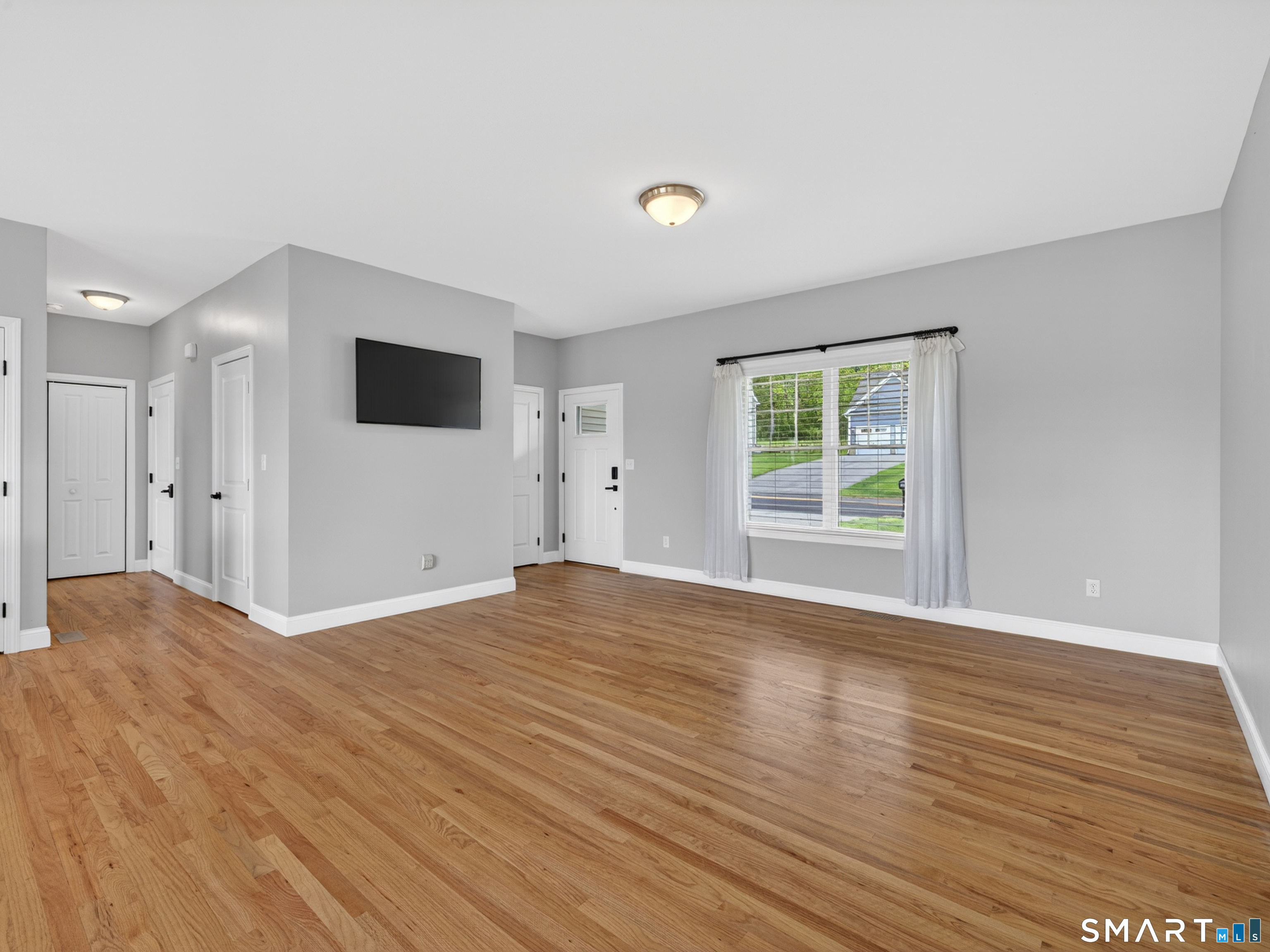 650 Ridgewood Road Middletown, CT 06457 - Photo 7 of 40 a view of empty room with wooden floor and windows