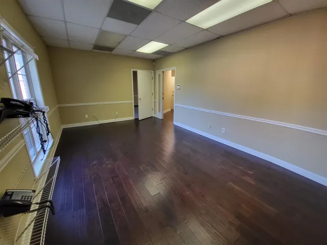 a view of room with wooden floor