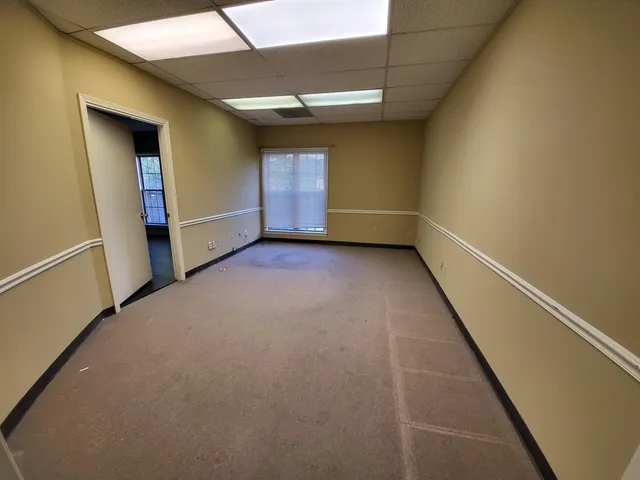 an empty room with wooden floor and closet