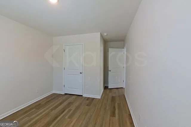 a view of room with wooden floor