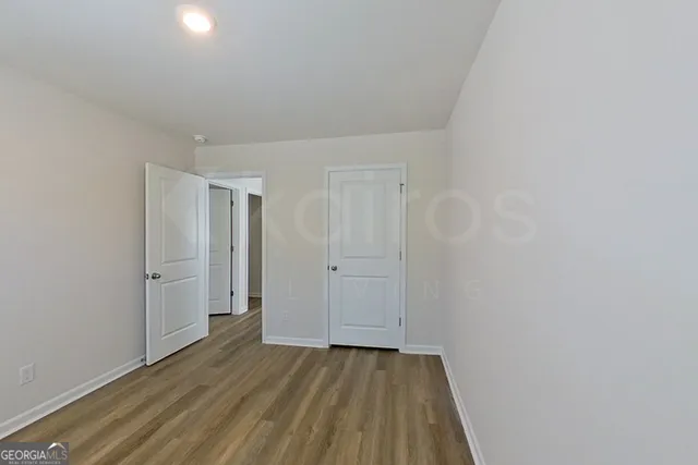 a view of an empty room and wooden floor