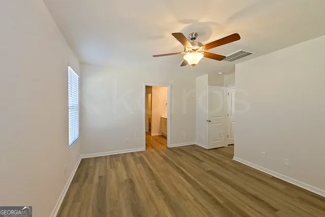 a view of room with wooden floor