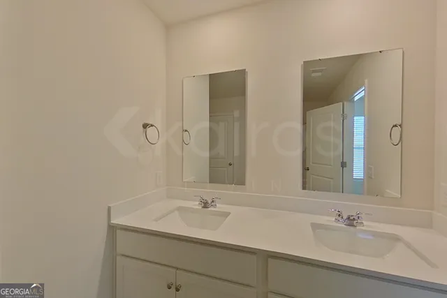 a bathroom with 2 sink and a mirror