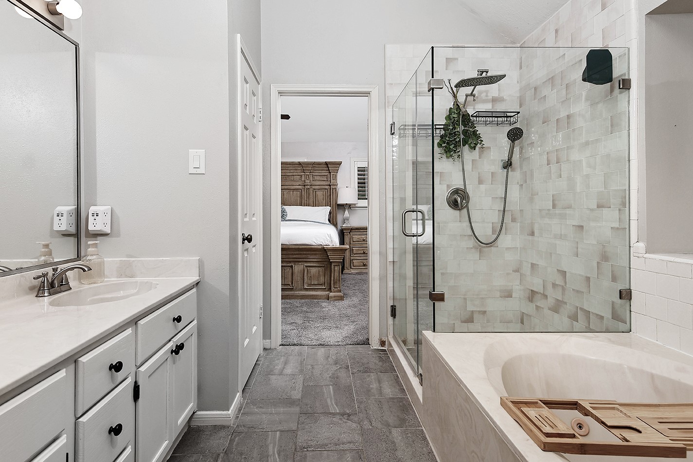 2619 Knollbrook Lane Spring, TX 77373 - Photo 18 of 27 a bathroom with a granite countertop sink a mirror a bathtub and shower