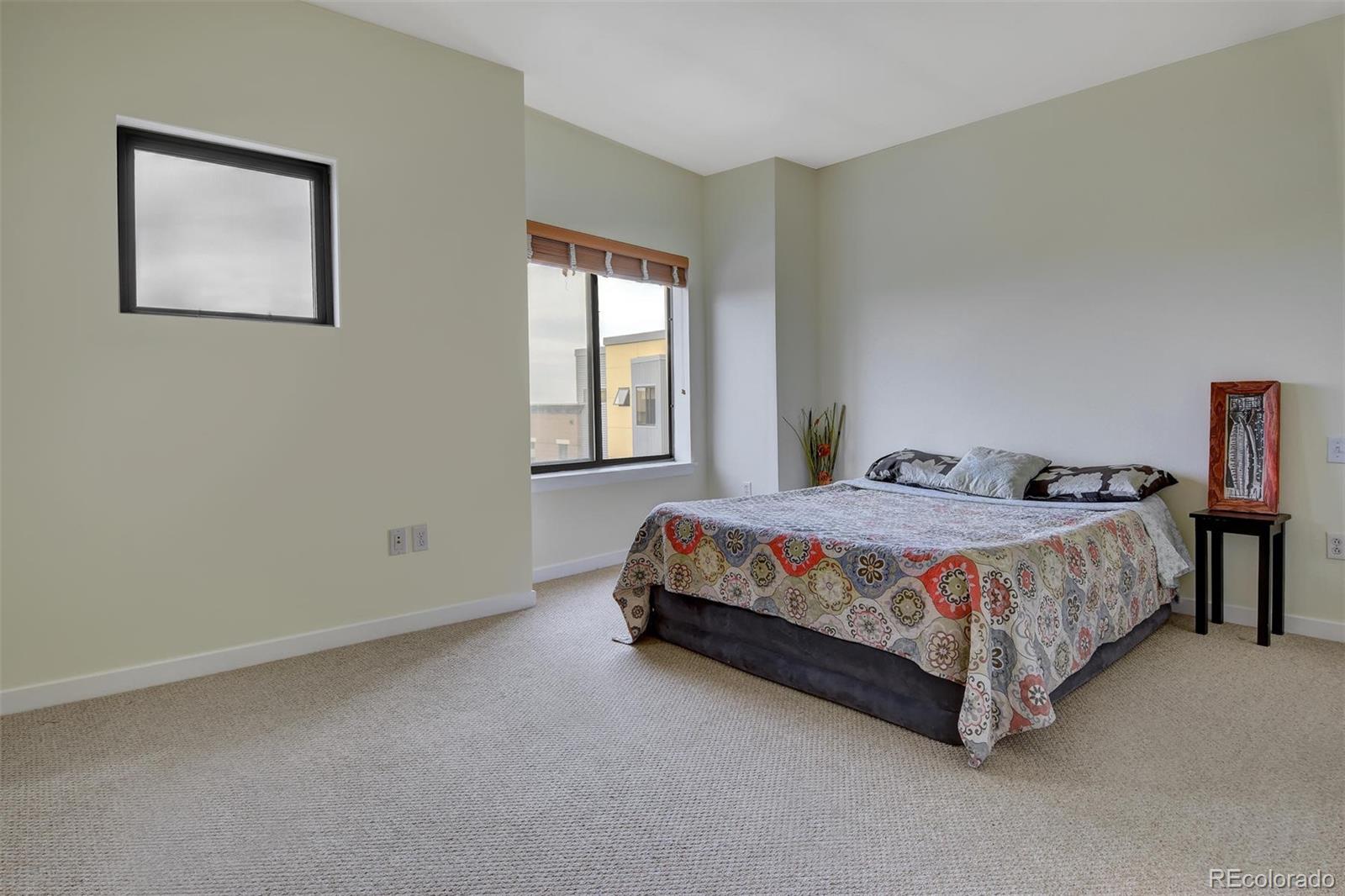 4520 Broadway, Unit 210 Boulder, CO 80304 - Photo 16 of 36 a bedroom with a bed lamp and window