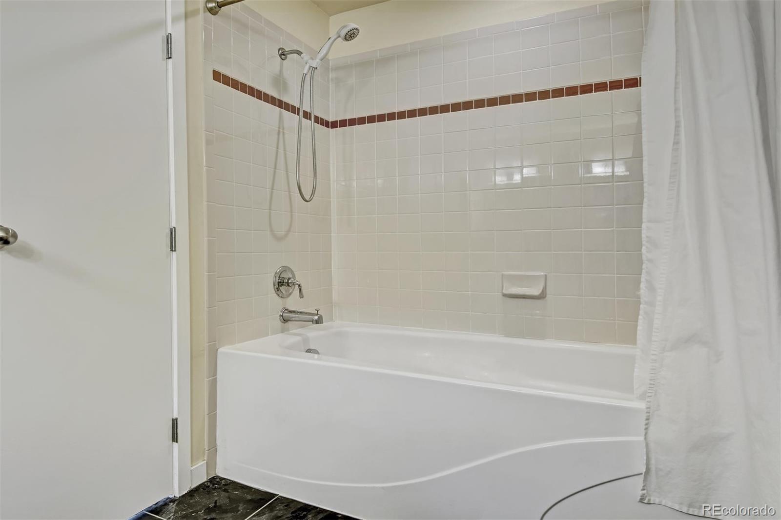 4520 Broadway, Unit 210 Boulder, CO 80304 - Photo 18 of 36 a bathroom with a bathtub and a shower