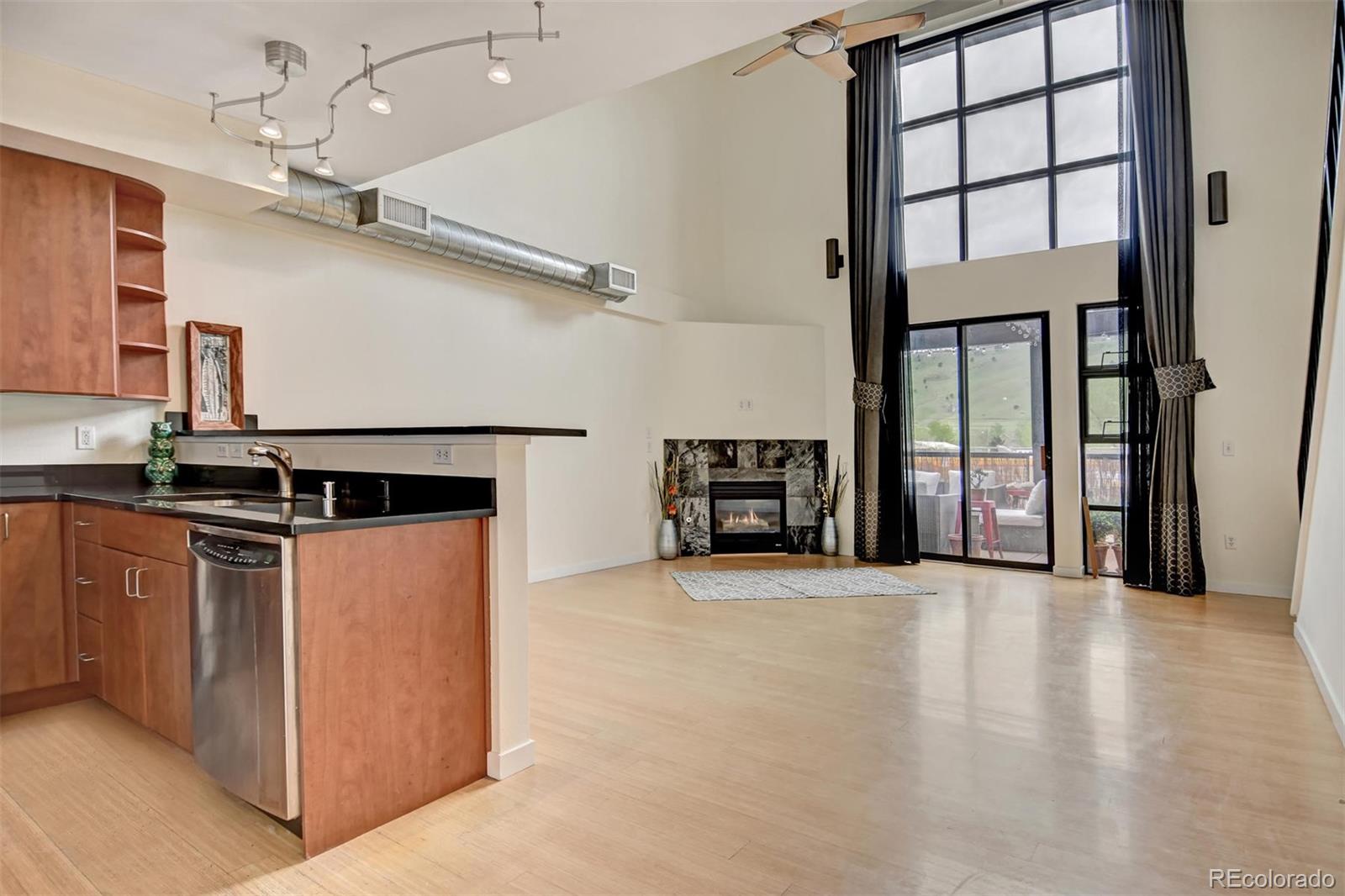 4520 Broadway, Unit 210 Boulder, CO 80304 - Photo 6 of 36 wooden floor in an empty room with a fireplace and a window