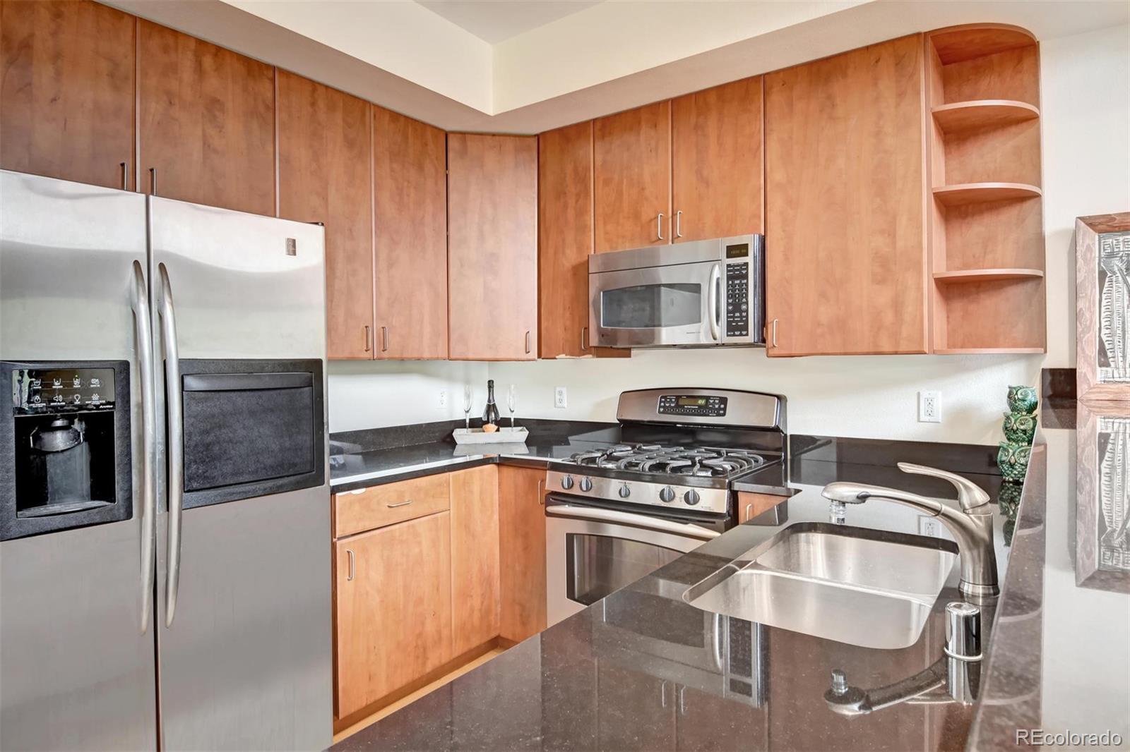 4520 Broadway, Unit 210 Boulder, CO 80304 - Photo 8 of 36 a kitchen with stainless steel appliances granite countertop a stove a sink and a microwave