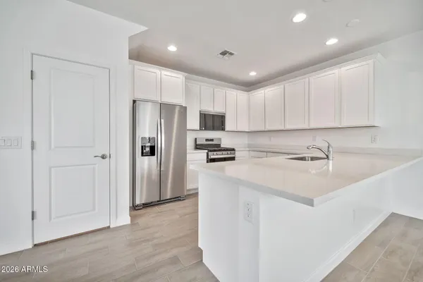 a kitchen with stainless steel appliances granite countertop a refrigerator sink and cabinets