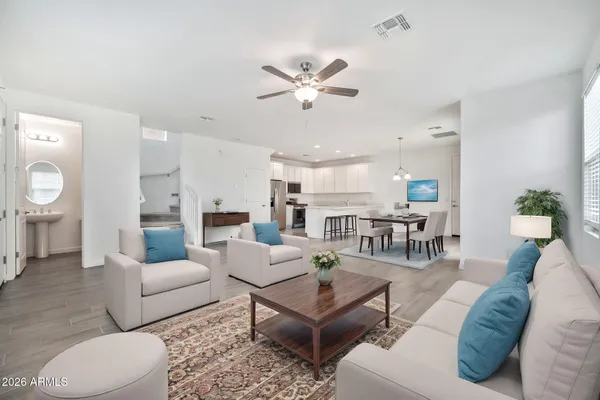 a living room with furniture and view of kitchen