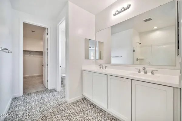 a bathroom with a shower and a glass door