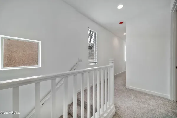 a bedroom with a balcony a bed and a painting on the wall