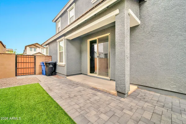 a view of a big yard with a table and chairs