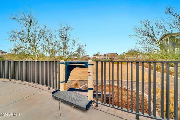 a front view of a building with garden and trees
