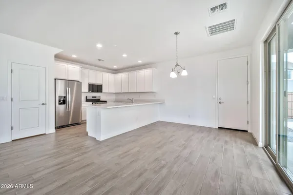 a view of kitchen with refrigerator oven and wooden floor